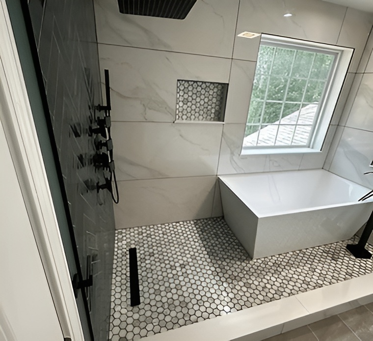 A spacious bathroom that includes a shower, bathtub, and sink, designed for comfort and convenience.