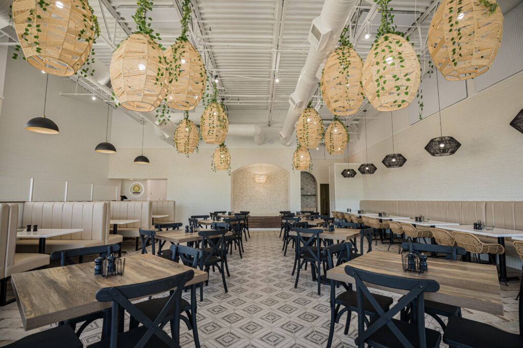 Commercial kitchen remodel in Carmel Indiana featuring elegant lighting, durable flooring, and open restaurant layout by Insta Pro Construction.