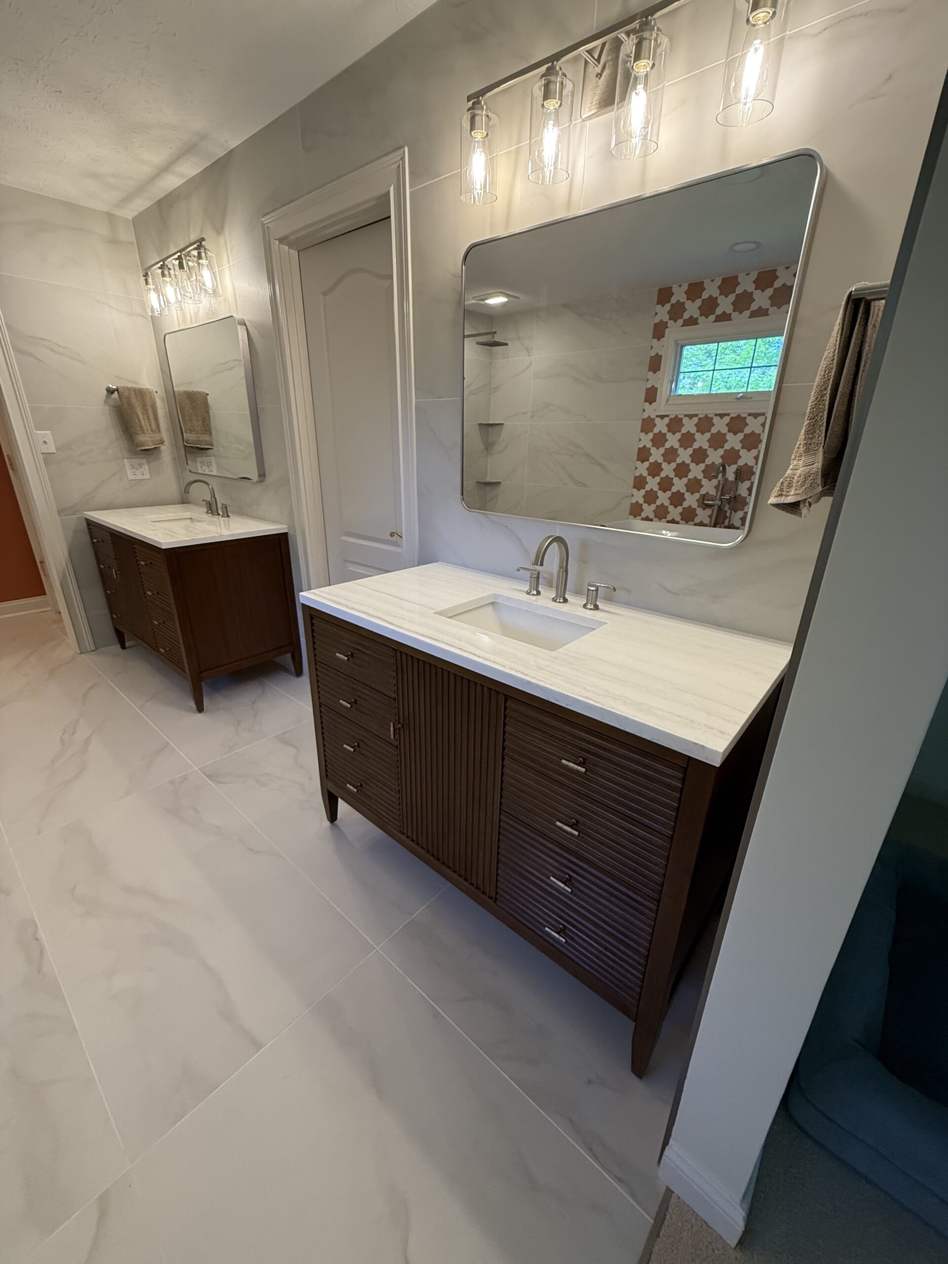 Luxury bathroom remodel in Zionsville IN featuring custom vanity, modern tile, and designer lighting by Insta Pro Construction.